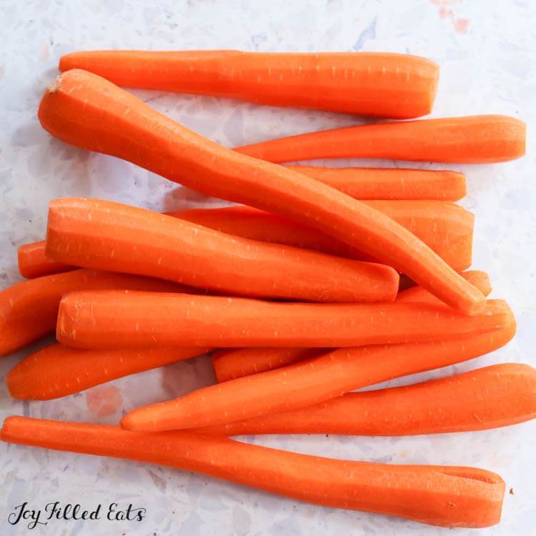 peeled carrots on surface