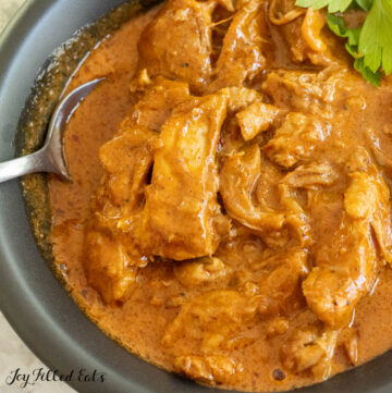 close up of chicken thigh curry in bowl