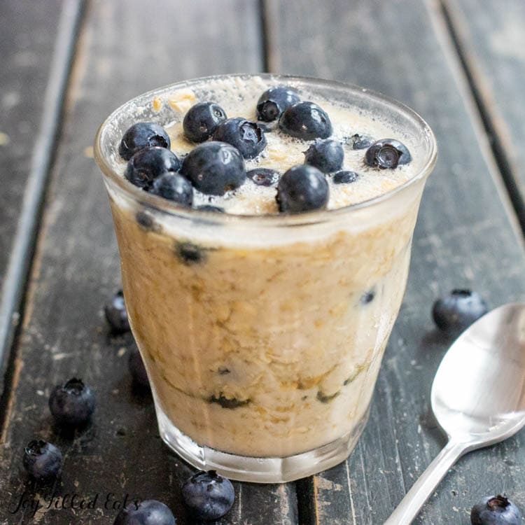 overnight oats with protein powder and blueberries in cup