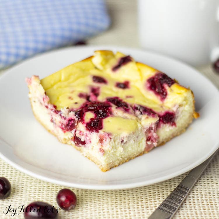 close up on one of the cranberry cheesecake bars on a plate