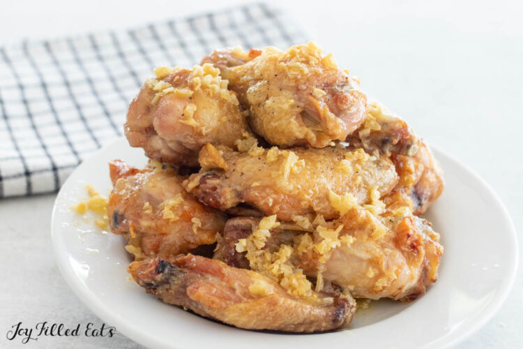 pile of garlic butter chicken wings on a plate