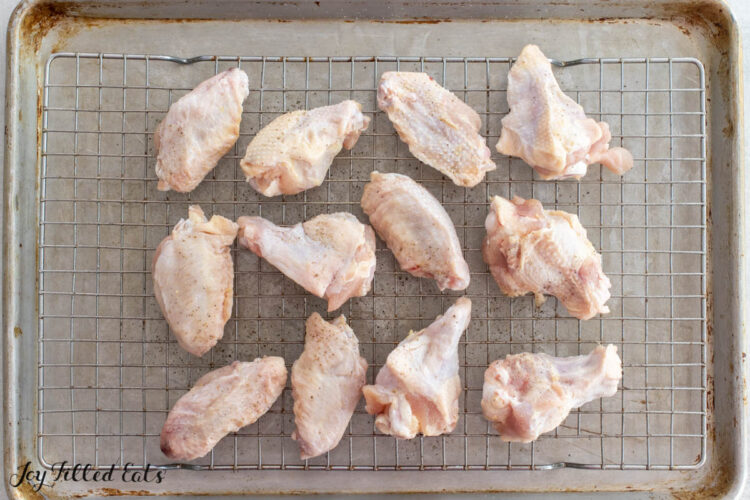chicken wings on a wire rack on top of a rimmed baking sheet
