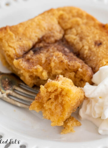 close up on a bite of keto pumpkin cake on a fork on a small plate