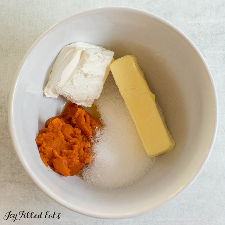 butter, cream cheese, sweetener, and pumpkin puree in bowl