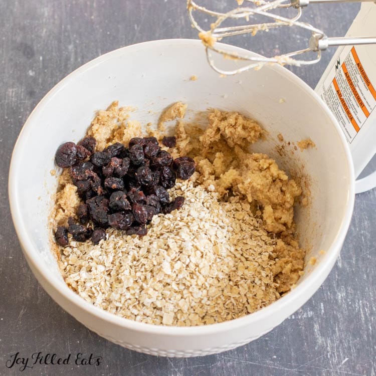 oats and cranberries added to bowl