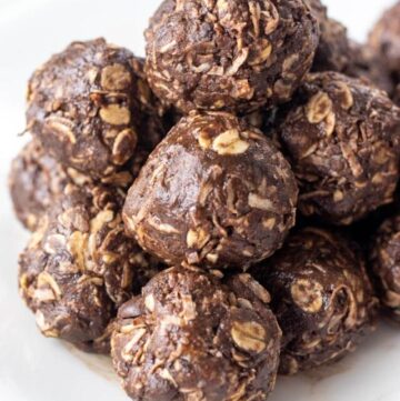 close up of a pile of chocolate bliss balls on a plate