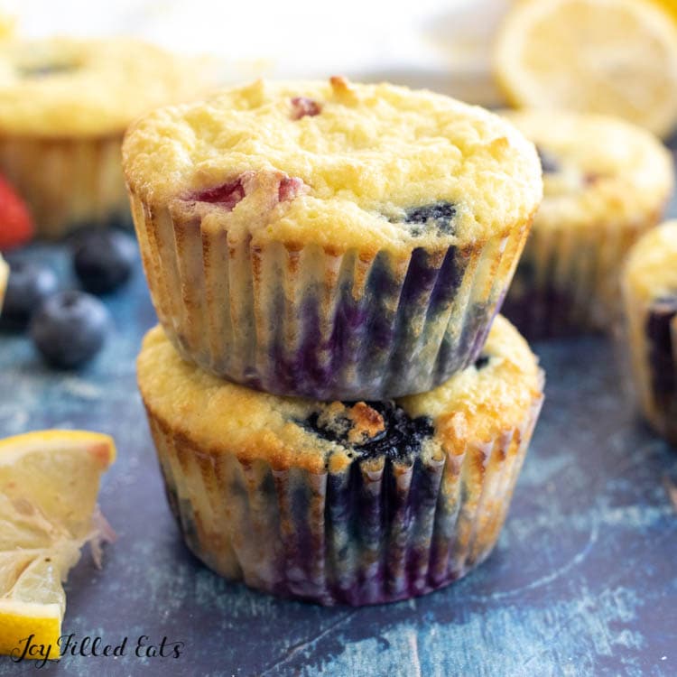 two keto lemon muffins with berries stacked