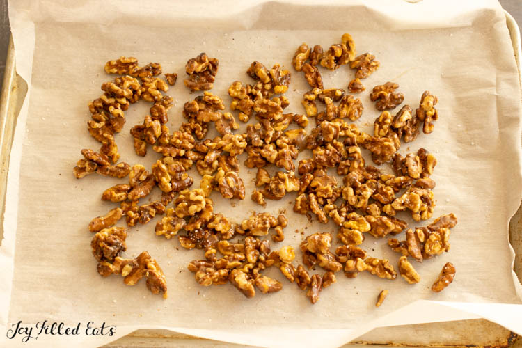 tray of candied walnuts on parchment paper