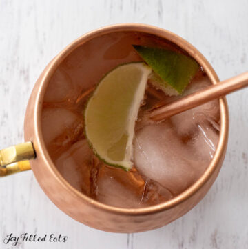 keto moscow mule in copper mug with lime and straw