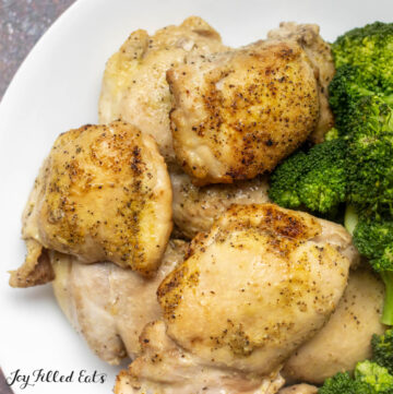 close up of air fryer boneless skinless chicken thighs on a plate with broccoli