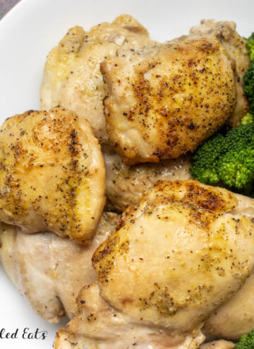 air fryer boneless skinless chicken thighs recipe served on a plate with broccoli