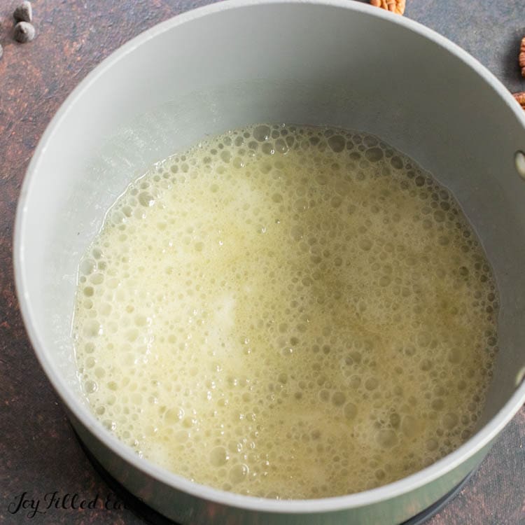bubbling yellow liquid in pot