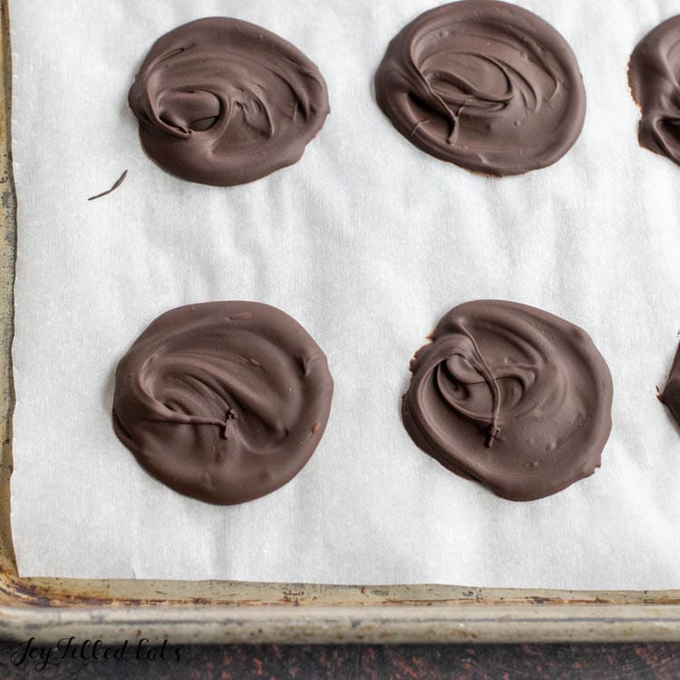 hardened circles of chocolate on parchment