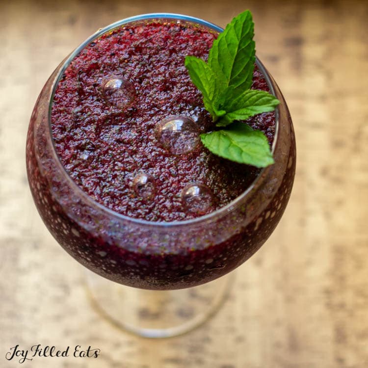 frozen blueberry mojito with mint garnish in large glass