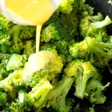 close up of pouring the lemon garlic dressing over the garlicy keto broccoli side dish recipe
