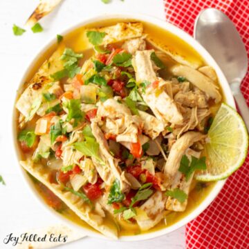 close up of keto chicken tortilla soup in a white bowl