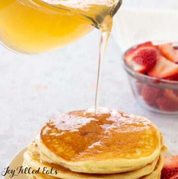 keto pancake syrup being poured over pancakes