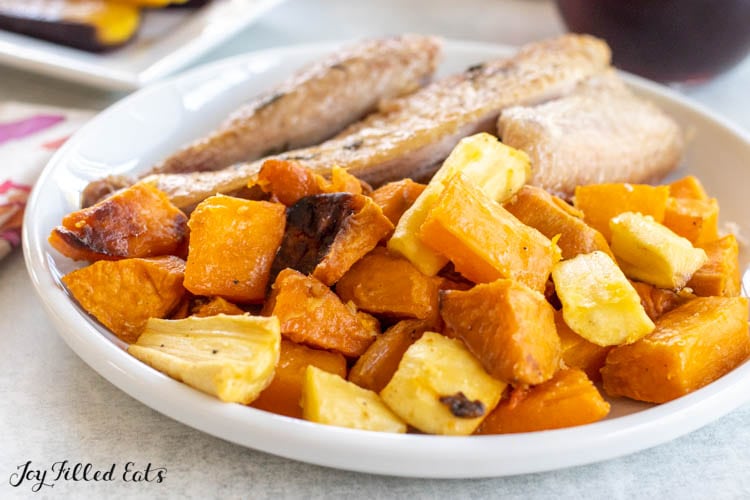 plate with poultry and roasted root vegetables