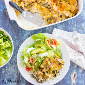 a serving of keto chile relleno casserole on a white plate with salad