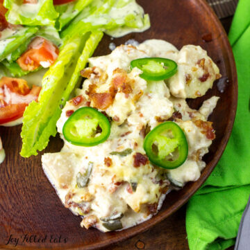 jalapeno popper chicken casserole on plate with salad