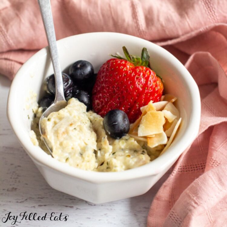 keto oatmeal in a bowl with berries and a spoon