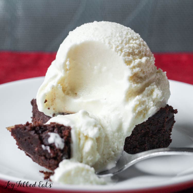 scoop from keto vanilla ice cream recipe on top of brownie