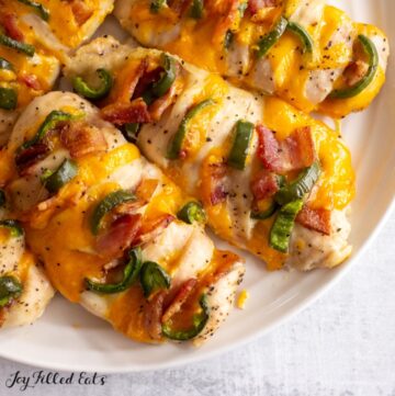 overhead shot of jalapeno popper hasselback chicken on a serving plate