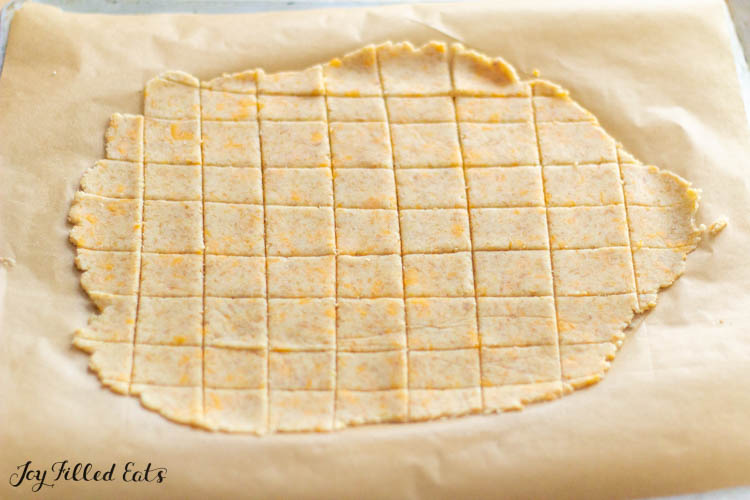 dough pressed out onto parchment paper and cut into squares