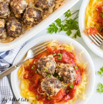 keto meatballs on top of a plate of spaghetti squash and sauce with fork from above