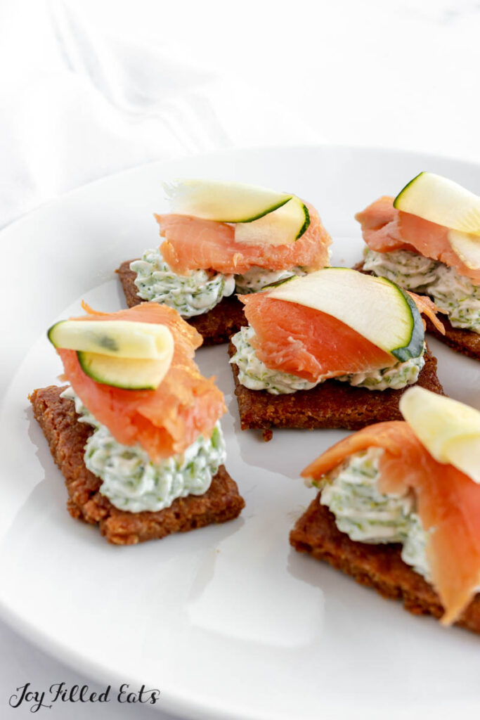 serving plate with smoked salmon bites topped with broccoli dip