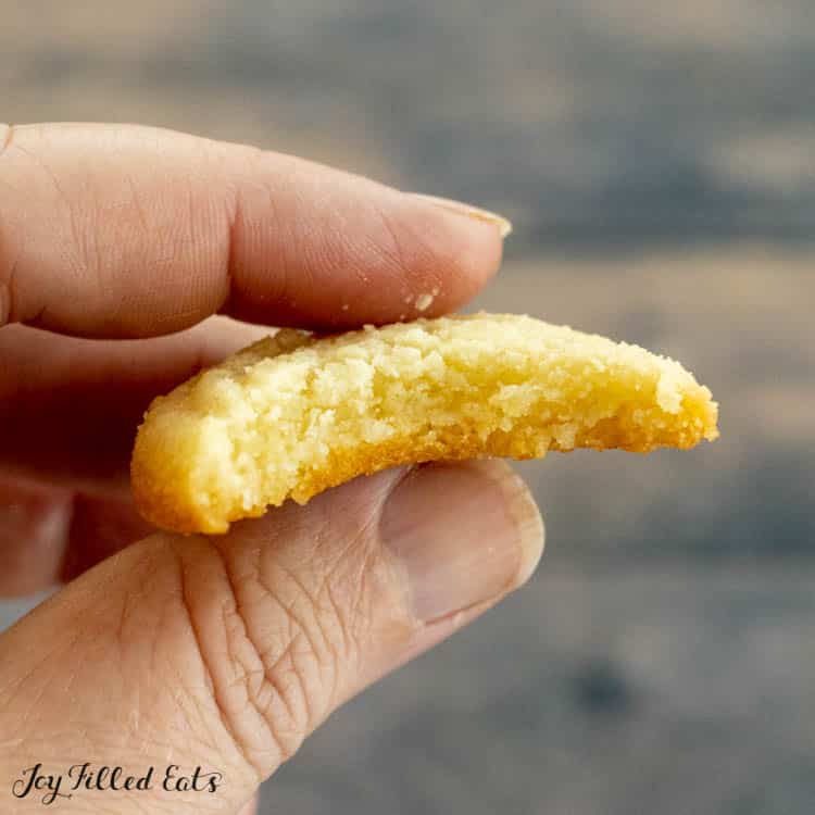 hand holding cookie with bite out of it