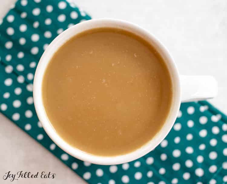 overhead shot of keto coffee recipe with heavy cream in mug
