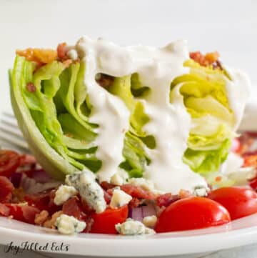 close up of a lettuce wedge salad with keto blue cheese dressing