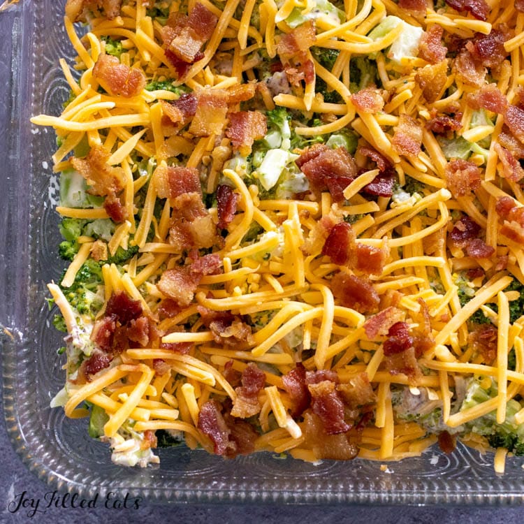shredded cheese and bacon on top of vegetable mixture