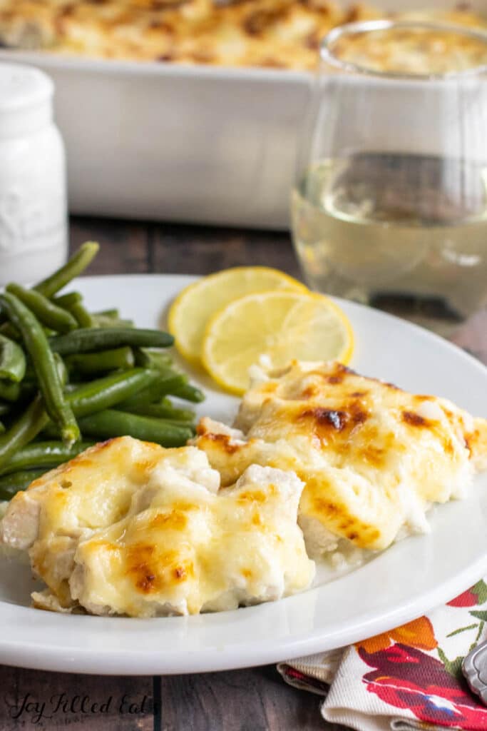creamy chicken piccata casserole served on a plate with green beans