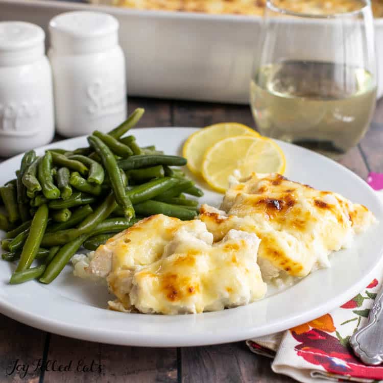 close up of creamy chicken piccata casserole recipe on a plate with green beans