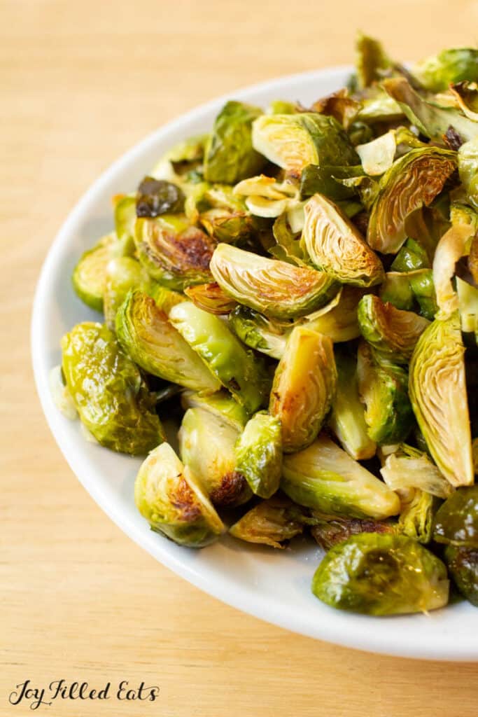 keto brussel sprouts with garlic in white serving bowl