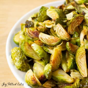 keto brussel sprouts with garlic in white serving bowl close up