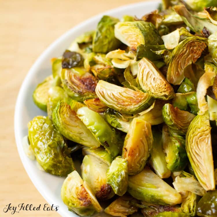 keto brussel sprouts with garlic in white serving bowl close up