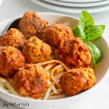 instant pot turkey meatballs seen from side with sauce and fresh basil