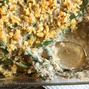 keto green bean casserole recipe in baking dish with spoon shown close up