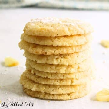 keto lemon cookies in a stack with slices of lemon around them
