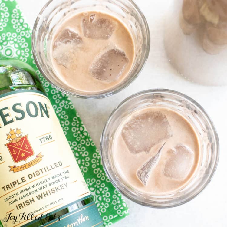 keto irish cream served in two glasses over ice next to a bottle of jameson