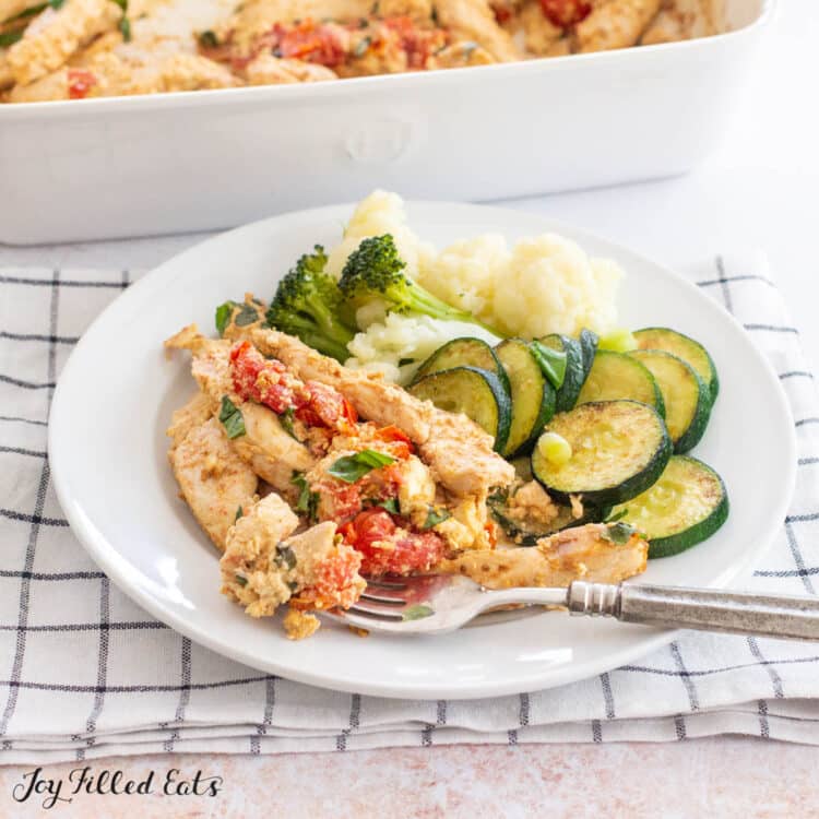 plates baked feta chicken with side of zucchini