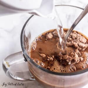 sugar free hot chocolate mix recipe in a mug with hot water being added