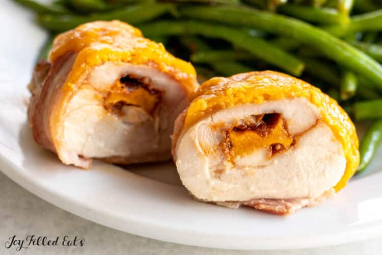 bacon wrapped stuffed chicken thigh cut in half