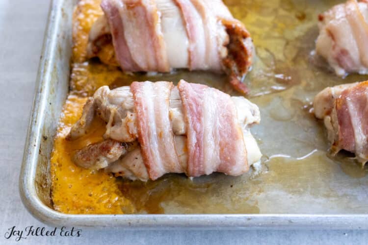 baked bacon chicken thighs on baking pan
