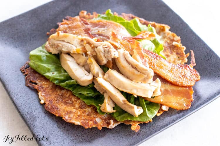 keto cheese tortilla on a plate with lettuce and chicken