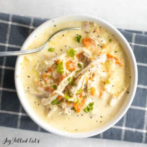 cream of chicken soup recipe in bowl garnished with parsley and black pepper