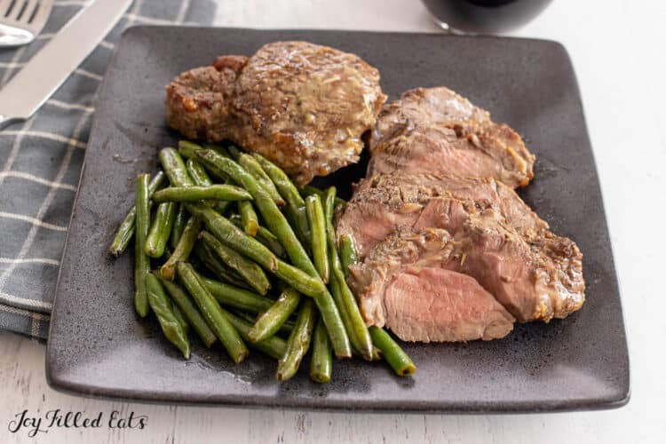 plate of sliced steak and green beans